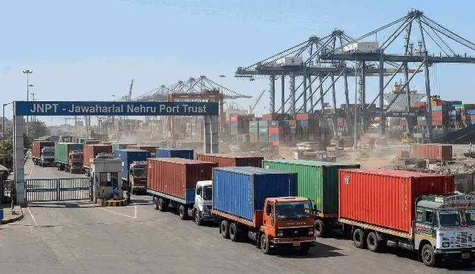 "Trucks carrying shipping containers from port to factory for import-export logistics."